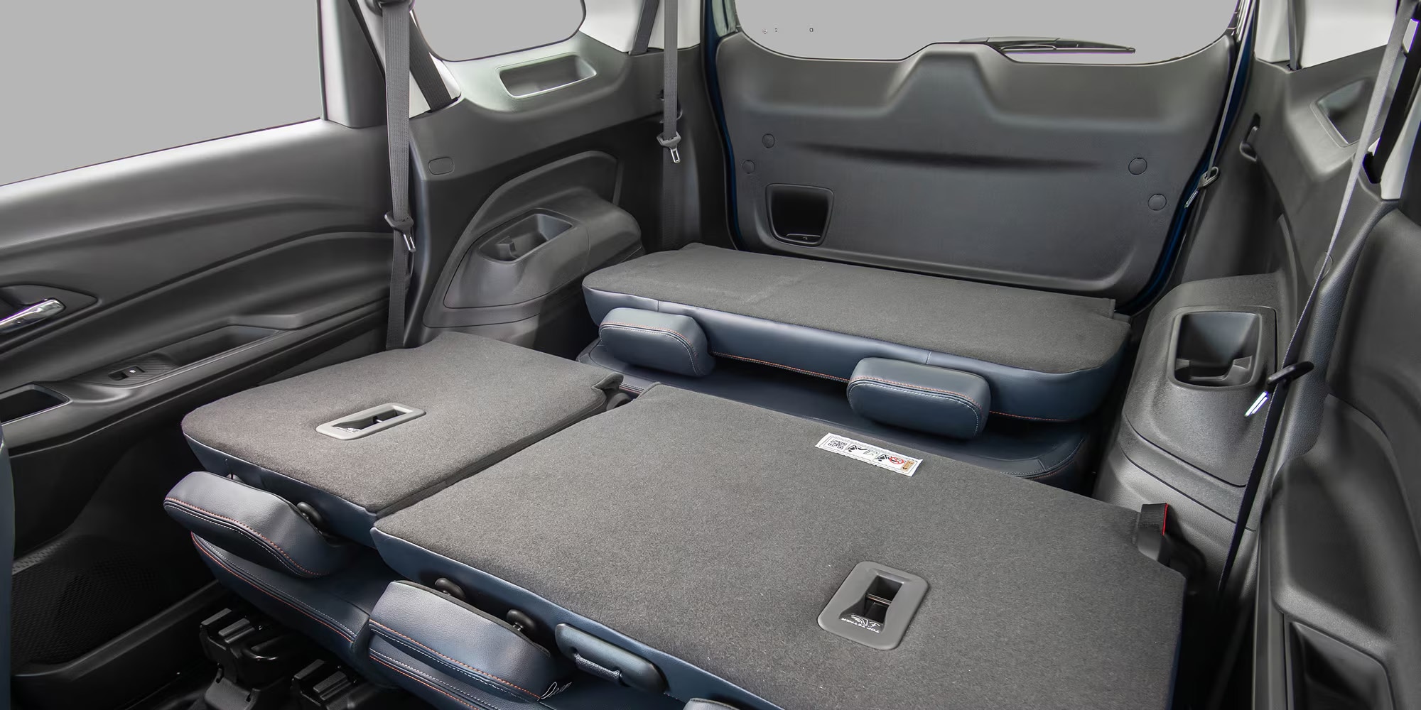 Interior da Chevrolet Spin 2026 com todos os bancos traseiros rebatidos, destacando a capacidade de carga.